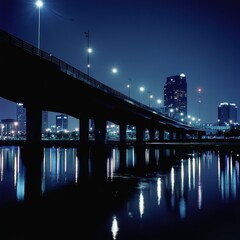 A high tech city bridge lined with subtle lighting reflecting over a dark moonlit river ar 16:9 v 6.1 q 2
