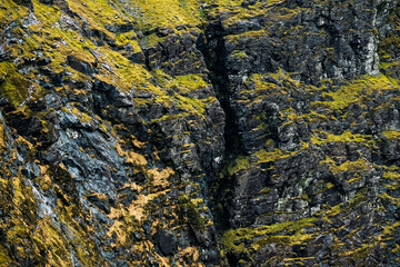 Explore the stunning Carrauntoohil walkway in Ireland surrounded by rocky landscapes and lush greenery.