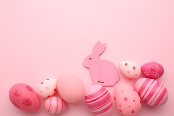 Easter holiday. Festive composition. Food decor. Homemade ornament. Creative colorful arrangement of painted pink blue yellow eggs with cute bunny chicken pattern isolated on light pastel background.