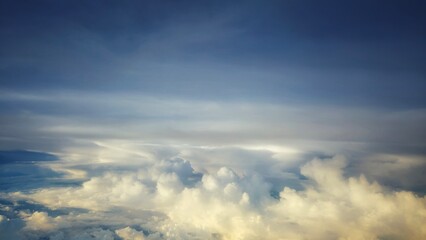 Majestic cloudscape with golden light and layered clouds stretching into the vast sky