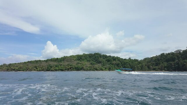 Speed boat in drake's bay.  Tourist boat coming back from Osa Peninsula in Costa Rica. Slow motion shot. 