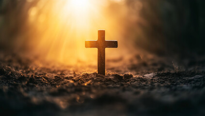 Fototapeta premium Wooden cross in soil with sunlight rays symbolizing hope, Christian religion concept