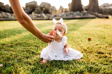 Mother handing child flower