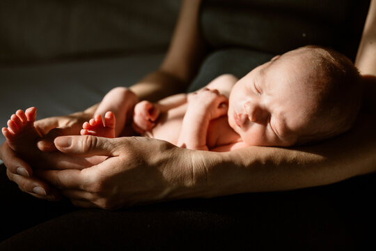 mom holding newborn baby 