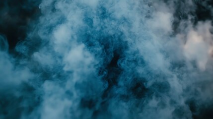 Obraz premium Blue smoke swirls on dark backdrop