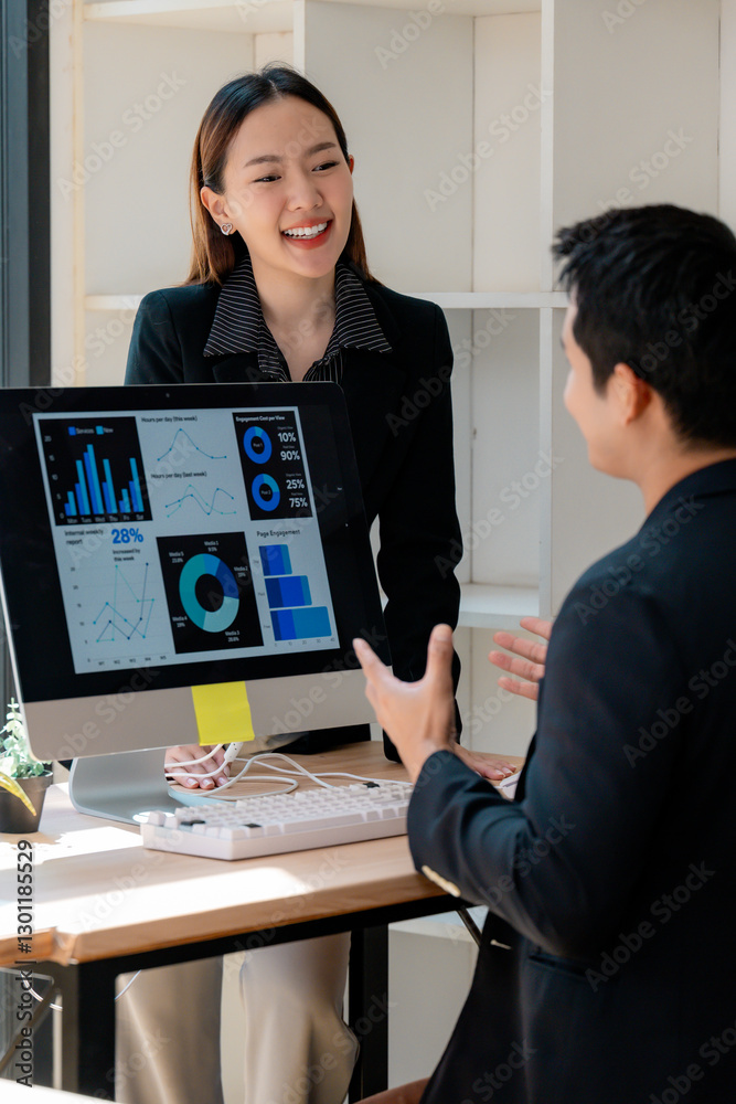 Poster Asian businesspeople discussing graphs and charts on computer screen