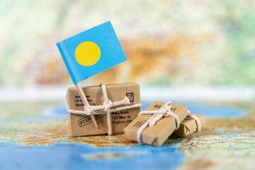 palau flag with small parcels on a world map, representing trade, island culture, and the global connections of this pacific nation © Alina