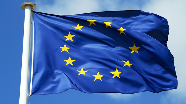 European Union flag against a blue sky. - Powered by Adobe