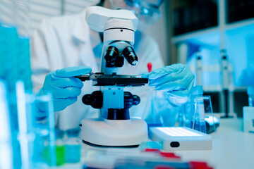 Scientist is using a microscope to examine a sample. Concept of curiosity and scientific exploration