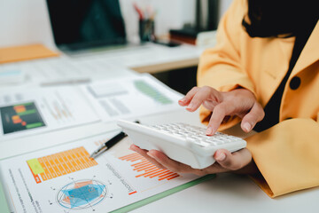 Portrait of a woman working on a tablet computer in a modern office. Make an account analysis report. real estate investment information financial and tax system concepts