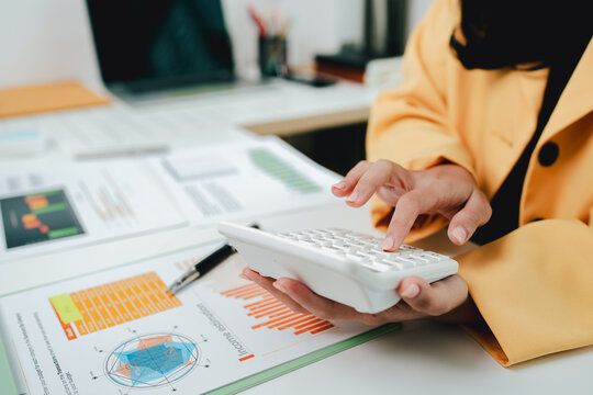 Portrait of a woman working on a tablet computer in a modern office. Make an account analysis report. real estate investment information financial and tax system concepts