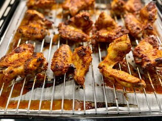 Homemade Chicken wings with sauce on wire rack