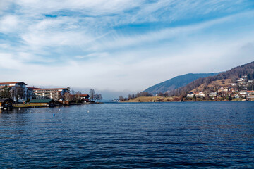 Beautiful Tegernsee lake in Upper Bavaria with a view of 'Kleiner Paraplui -Tegernsee', the beach and the Leeberg district facing the Rottach Bay
