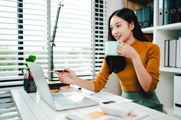 Brightly smiling businesswoman working on tablet at office Female employees check business...