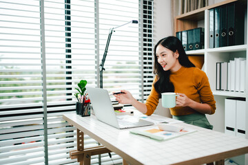 Brightly smiling businesswoman working on tablet at office Female employees check business documents, check accounts, search documents, legal documents, prepare documents, reports, analyze taxes.