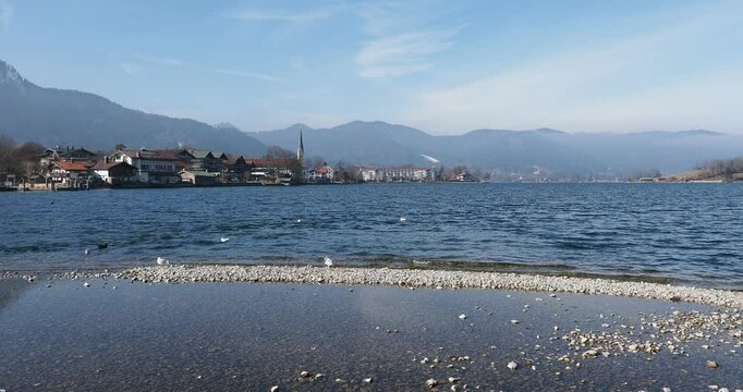 On the shores of Lake Tegernsee. Rottach Bay between the jetty of the Rottach river and the point -Tegernsee, surrounded by the Bavarian foothills