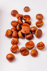 raw edible chestnuts on the white background