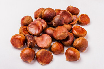 raw edible chestnuts on the white background
