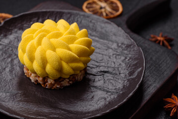 Round sweet tart of yellow color with citrus and passion fruit flavor