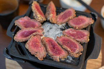 Set of Gyukatsu or beef cutlet on the grill. A traditional Japanese food that consists of a deep-fried beef cutlet.