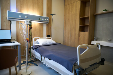 Close-up view of a hospital bed with attached medical equipment