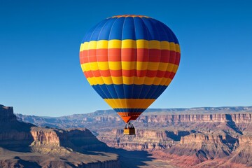 Fototapeta premium A hot air balloon floating over a canyon at sunrise, offering a breathtaking view