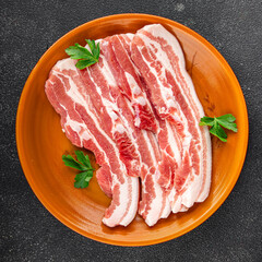 Bacon slices pork meat fresh delicious gourmet food background on the table rustic food top view copy space