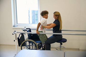 Patient practices maintaining balance while standing
