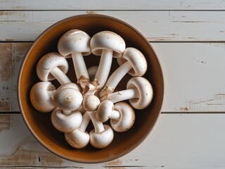 Fresh white champignon mushrooms in a brown bowl centered on a rustic wooden table with ample negative space on the right for text or design