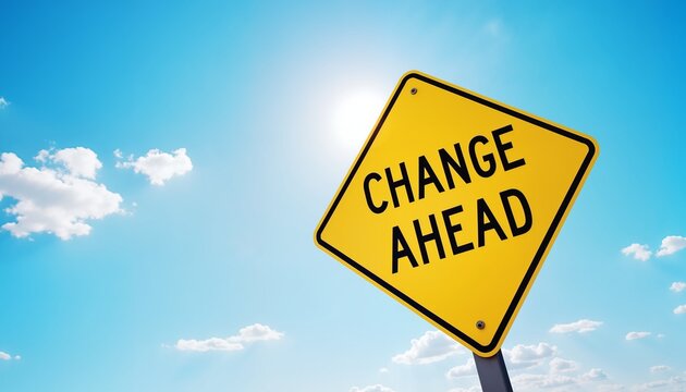 Yellow road sign with Change Ahead message, blue sky background, concept of change