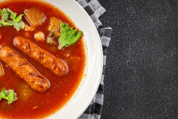 Tomato soup with sausages fresh tasty food dish delicious gourmet food background on the table rustic food top view copy space