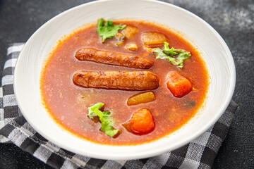 Tomato soup with sausages fresh tasty food dish delicious gourmet food background on the table rustic food top view copy space