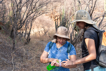 Hikers Using a Smartwatch During a Nature Trail Trek