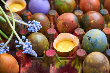 painted multicolored eggs for Easter in a modern style palette in dark blue tones, top view