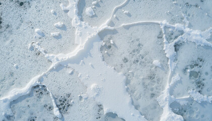 Obraz premium Bird's-eye view of thawing spring pond with ice breaking, seasonal transition