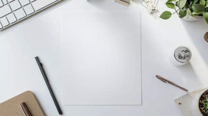A white piece of paper sits on a desk with a pen and a pencil