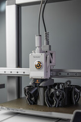 3D printer prints an object. The process of printing model on 3D printer. Model printed on 3D printer from molten plastic. 3D printing technologies. Additive progressive new modern printing technology