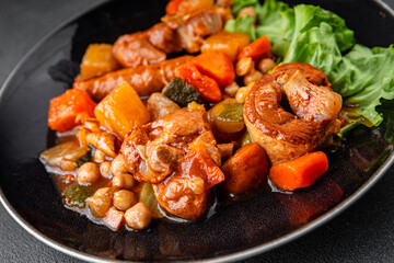 Ragout meat, sausages, vegetables stew dish fresh tasty food delicious gourmet food background on the table rustic food top view copy space