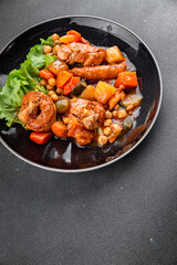 Ragout meat, sausages, vegetables stew dish fresh tasty food delicious gourmet food background on the table rustic food top view copy space