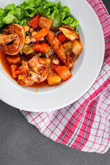 Ragout meat, sausages, vegetables stew dish fresh tasty food delicious gourmet food background on the table rustic food top view copy space