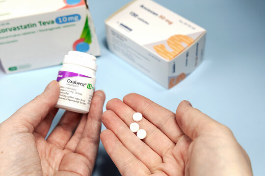 Female hands holding Oxabenz sedative pills. Prescription medication
