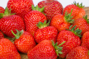 ripe strawberries on white background, close up