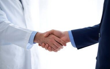 Two doctors shaking hands in a bright, white room, symbolizing collaboration and professionalism in healthcare Generative Ai.