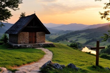 Obraz premium Small stone church overlooking scenic valley at sunset with wooden cross