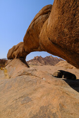 The iconic Spitzkoppe arch framing the 1728m Spitzkoppe peak in the Namibian desert.