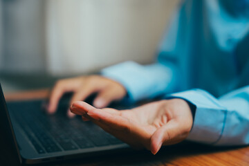 Business Professional Gesturing While Using Laptop in Modern Workspace Environment, Business concept.