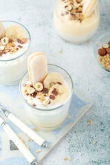 Milk mousse dessert with nuts in glasses	