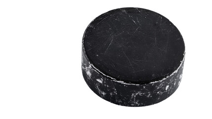 Scratched and worn hockey puck on transparent background