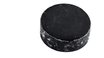 Scratched and worn hockey puck on transparent background
