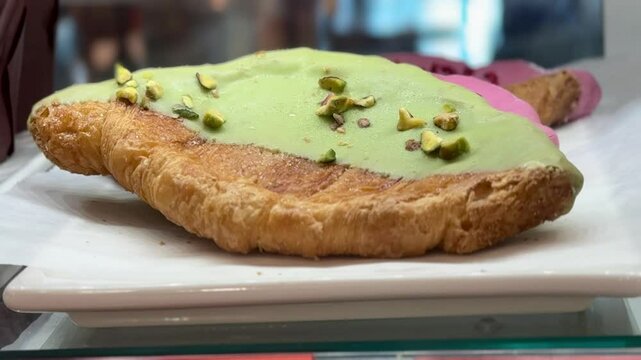 Freshly baked almond croissants with a wide assortment are elegantly laid out in a beautiful showcase for regular visitors. Close-up.